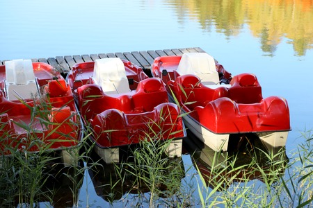 Red floating pedal bicycle boatsの写真素材