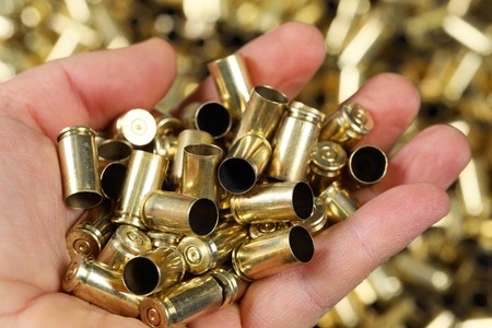 Gun bullets hold in hand