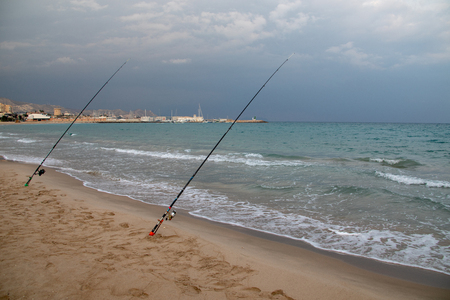 Fishing rods set up on beach shoreの写真素材