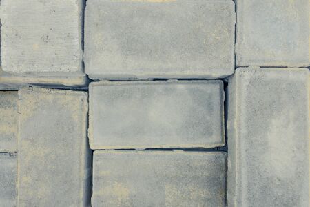 laid paving slabs at the site of the reconstruction of the square pavement road. background of paving gray tilesの写真素材