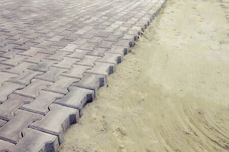 paving slab laying works, road repair, pavement restoration, square restoration works, background, paving slabs in the sandの写真素材