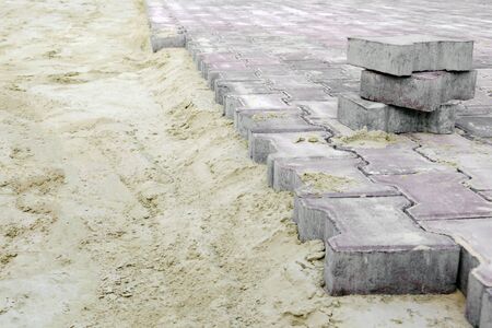 pavement renovation. Paving bricks ready for construction work. Laying paving slabs on a city square, sidewalkの写真素材