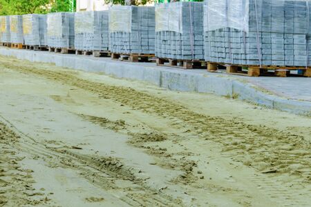 road works on laying paving slabs with laying of sandの写真素材