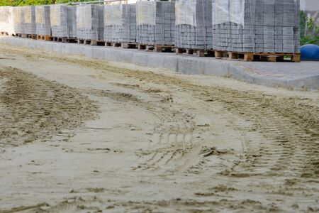 road works on laying paving slabs with laying of sandの写真素材
