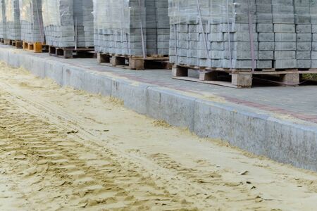 road works on laying paving slabs with laying of sandの写真素材