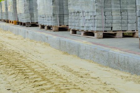 road works on laying paving slabs with laying of sandの写真素材