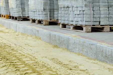 road works on laying paving slabs with laying of sandの写真素材