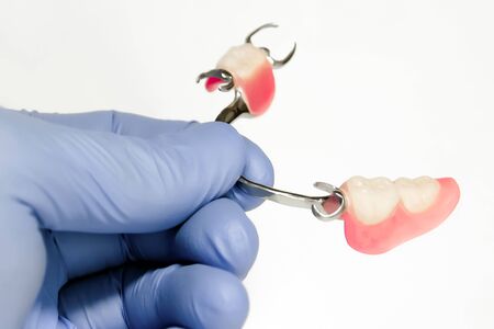partial arch prosthesis of the lower jaw in the hands of the dentistの写真素材
