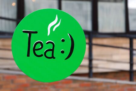 green retro outdoor tea sign. pointer in the morning on the streetの写真素材