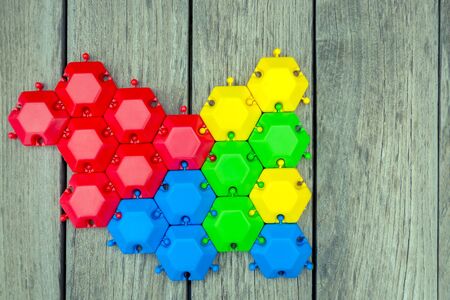 multi-colored puzzle, puzzle on a gray wooden background. concept of unity, business, developed thinking, strategy, support, care. Creative thinking. Abstractionの写真素材