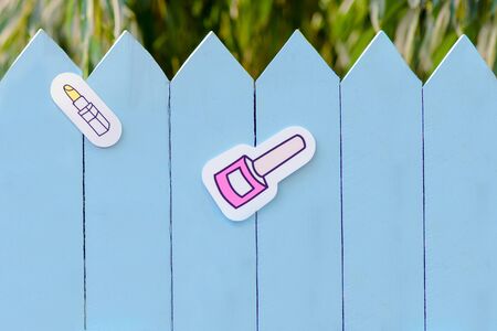 lipstick and nail polish on a wonderful blue fence. background with copy space. The concept of beauty industry, beauty salons, makeup, nail serviceの写真素材