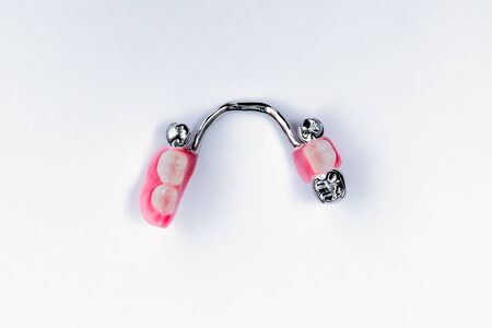 clasp prosthesis on the lower jaw. metal support crowns. false teeth. lower jaw. White backgroundの写真素材