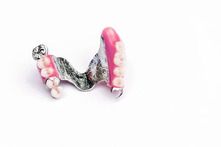 clasp prosthesis on the upper jaw. upper denture. false teeth. ceramic teeth. removable denture. White backgroundの写真素材