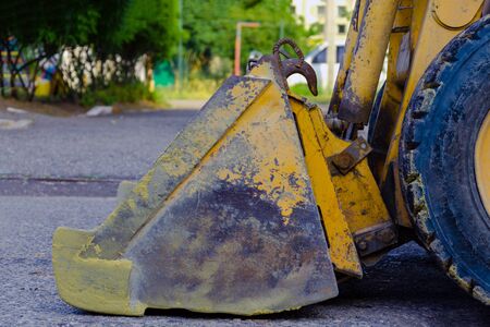 industrial construction work. tractor loader with a dirty scratched bucket after loading sand. construction work concept. backgroundの写真素材