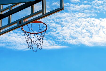 outdoor basketball game concept. basketball net against the blue sky with clouds. backgroundの写真素材