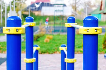 Parallel bars. Close-up photo on exercise machines in the park. against the background of a basketball court with people. healthy lifestyle conceptの写真素材