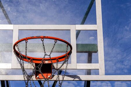 basketball hoop on a background of blue sky with clouds. sunny. background for basketball subjectsの写真素材