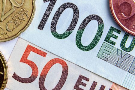 50 and 100 euros close-up. Euro cents are located on the sides. investment concept. bankingの写真素材