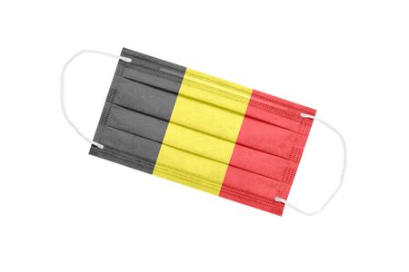 Medical mask with the flag of Belgium isolated on a white background. Belgium pandemic concept. attribute of coronavirus outbreak in Belgium. Medicine in Belgium.の写真素材