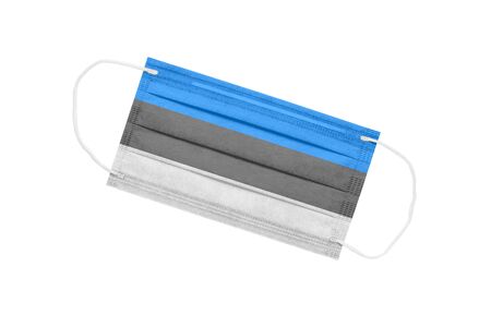 Medical face mask with flag of estonia isolated on white background. pandemic concept in Estonia. Attribute of coronavirus outbreak in Estonia. Medicine in Estonia.の写真素材