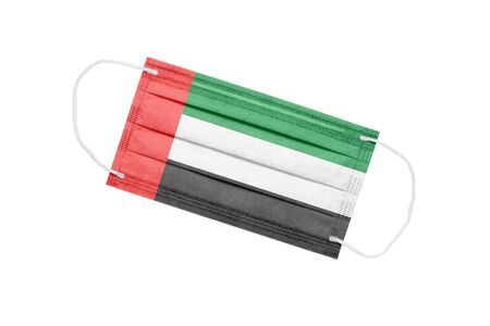 Medical face mask with flag of united arab emirates isolated on white background. pandemic concept in united arab emirates. attribute of an outbreak of coronavirus in the UAE. Medicine in the united arab emirates.の写真素材