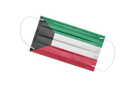 Medical mask with the flag of Kuwait isolated on white background. Kuwait Pandemic Concept. Attribute of coronavirus outbreak in Kuwait. Medicine in Kuwait.の写真素材