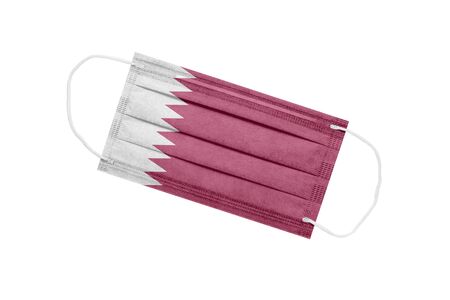 Medical mask with flag of Qatar isolated on white background. Qatar pandemic concept. Attribute of a coronavirus outbreak in Qatar. Medicine in Qatar.の写真素材
