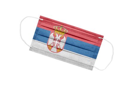 Medical mask with flag of Serbia isolated on white background. The concept of a pandemic in Serbia. Coronavirus outbreak attribute in Serbia. Medicine in Serbia.の写真素材