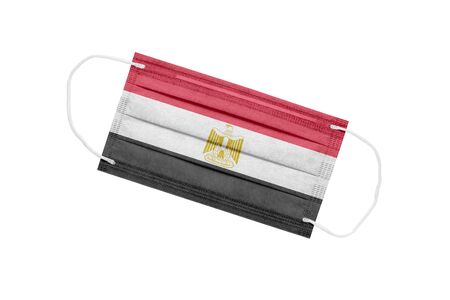 Medical mask with flag of egypt isolated on white background. The concept of the pandemic in Egypt. Attribute of a coronavirus outbreak in Egypt. Medicine in Egypt.の写真素材