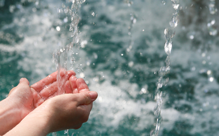 Drinking water & natural water in the hands.の写真素材