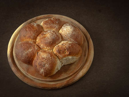 Freshly baked buns on a wooden board