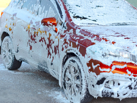 Car covered with foam at a car washの写真素材