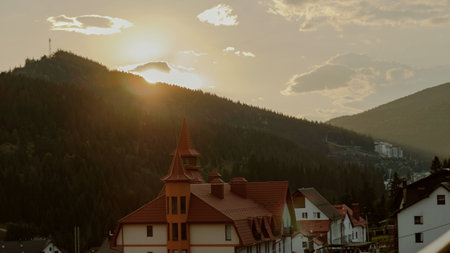 The sun sets behind Bukovel mountain. View from the village of Polyanytsia. Ivano-Frankivsk region. Ukraineの写真素材