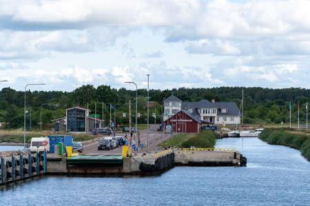 Estonia, Soru - 2021.07.19 - Port of Soru, Hiiumaa island. View of the pier where cars and people are waiting to get to the ferry.のeditorial素材