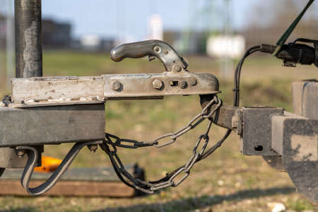 towing hook for wood chipper with car with safety chainIn the background a springy, sunny day.の写真素材