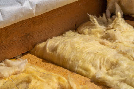 close-up of roof rafters and stone wool insulationopen roof pie with close-up wooden rafters, cross-slat and thermal insulation layerの写真素材