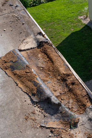 defectation - damaged roof waterproofing and broken OSB boardsopen roof waterproofing layer detecting damaged OSB board and rotten bitumen waterproofingの写真素材