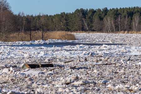 the entire width of the river is filled with ice floes and ice ravines flowing into the sea. Along with the ice cubes, the metal pontoon part flows away.の写真素材