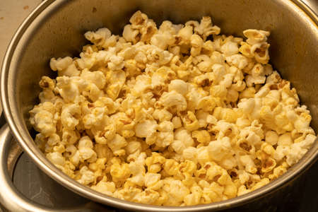 Freshly made popcorn can be seen in the kitchen potの写真素材
