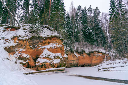 The frozen Rauna River, which is covered with a layer of ice, winds past the Vander Rockの写真素材