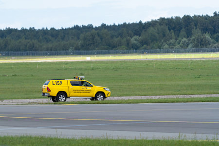 Marupe, Latvia - August 4, 2023 - RIX airport. An airport service car with sign "Bird and wildlife control" painted on side.のeditorial素材