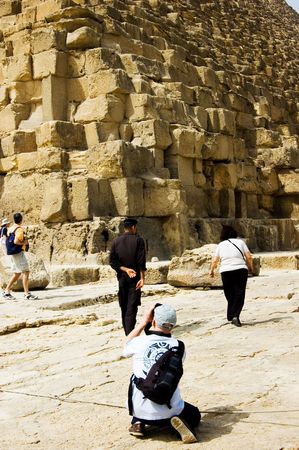 A man taking picture of Pyramidsの写真素材