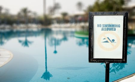 No Swimmin Allowed over swimming pool background.の写真素材
