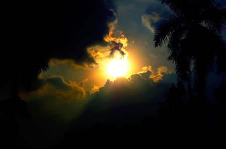 Sun shinning through clouds.Exposed background.