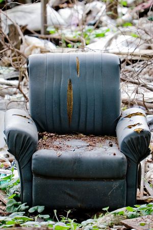 Chair in the middle of junk yard.の写真素材
