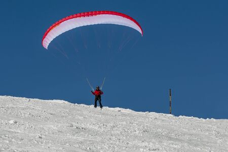 Paraglider in the snow mountain satrtの写真素材