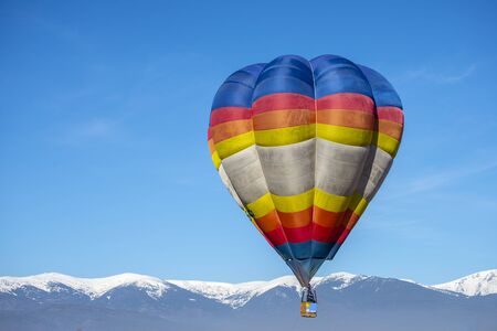 Hot air Baloon in the beatiful mountain in the winter colorfullの写真素材
