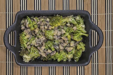 Broccoli and fungi with butter and cheeseの写真素材