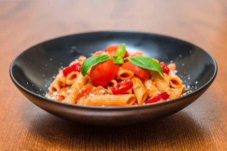 Rigatoni a la matriciana cherry tomato basilicoの写真素材