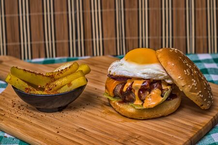 Burger egg cheddar french-fries backgroundの写真素材
